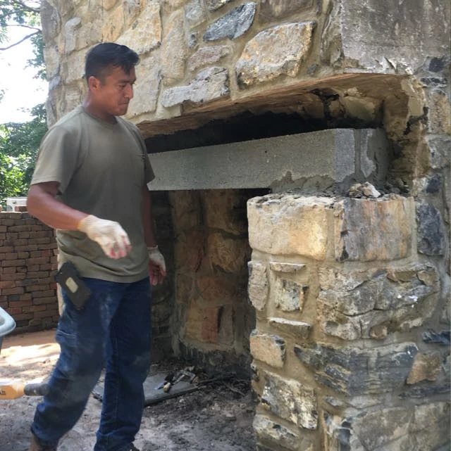 Alfonso, founder of Xalapa Masonry, beside a stone masonry project